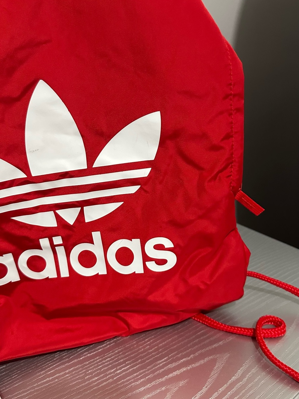 Red Adidas backpack with white logo with side pocket